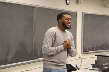 Jehron Petty speaking in a classroom.