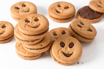 Pile of smiley sandwich cookies.