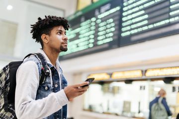 Person at the airport with a smartphone.