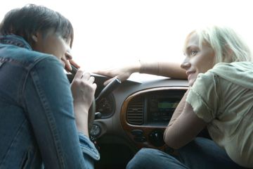 Two people listening to radio in the car