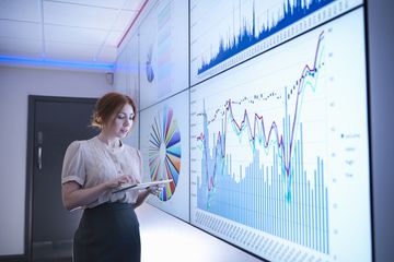 A data scientist uses an iPad with a projector