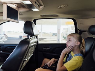 A girl streams television in a car.