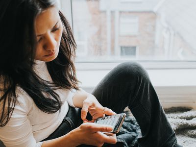 Perplexed woman looking at phone.