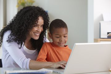 grades pressure - mom and son on computer, smiling