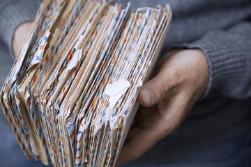 Man holding letters in envelopes