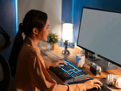 A woman looking at static on her computer monitor.