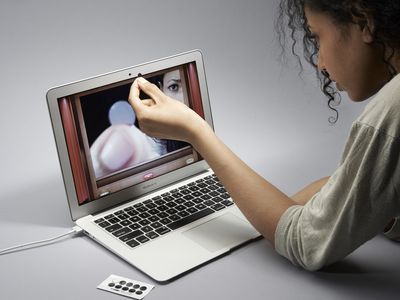 A person covering a laptop webcam