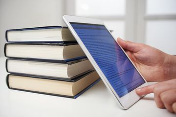 Picture of books and a tablet with an ebook