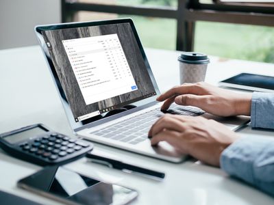 Person using Chrome Task Manager on a laptop in an office