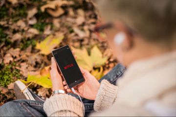 A student accesses Netflix on their phone.