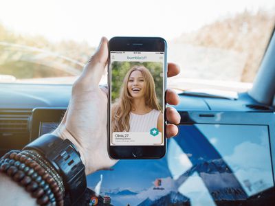 A man looking at a Bumble profile on an iPhone.