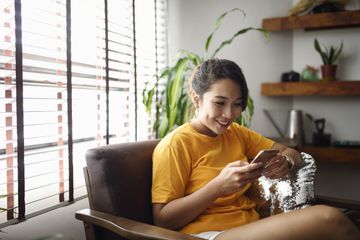 Person using smartphone at home.