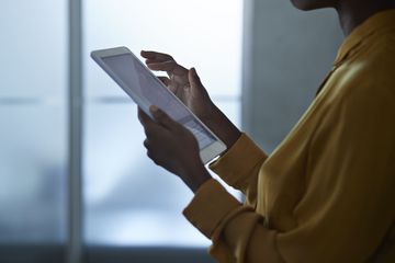 Save to Board Close-up of businesswoman using tablet, at office