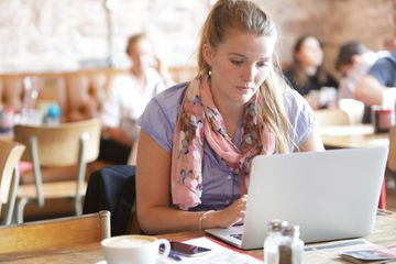 Woman working on laptop in coffee shopp