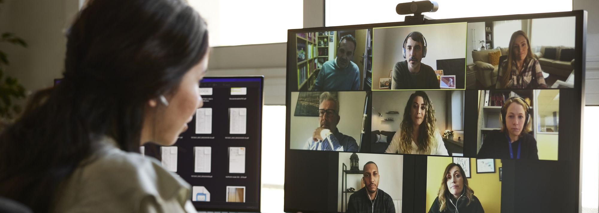 Woman working from home attending a video conference call.