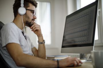 A man listening to music on an iMac