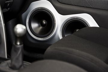 Passenger side speakers in a car