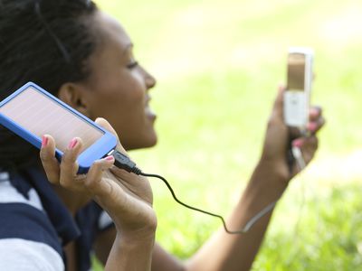 woman charging a phone with a solar charger