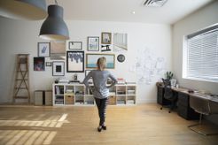 Woman looking at gallery wall in her home