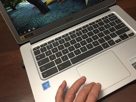 Someone using the touchpad on a Chromebook.