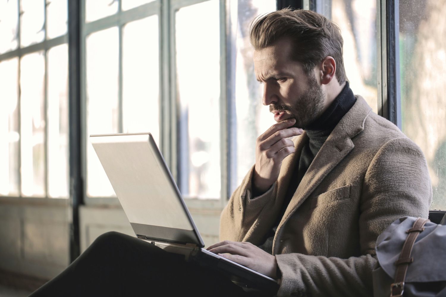 Person looking at computer, and also looking handsome. 