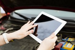 Person using an iPad with a black screen