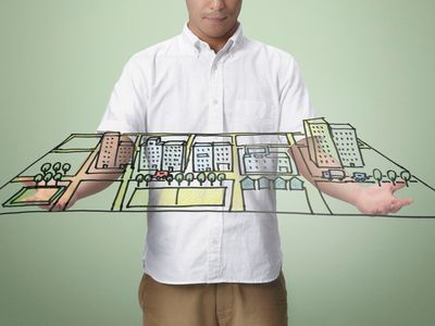 Man virtually holding hand drawn sketch of a town