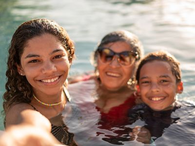 Family, grandmother and grandchildren in swimming pool.