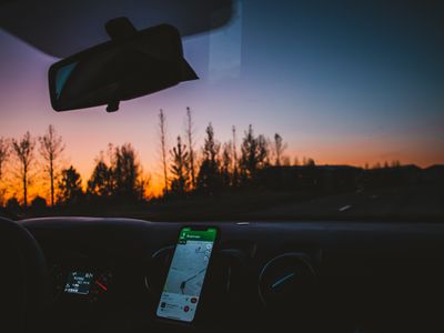 Car interior showing a phone with GPS navigation