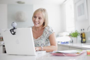 Smiling woman enjoying video chat on laptop