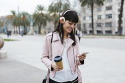 Person on the beach listening to music on a phone