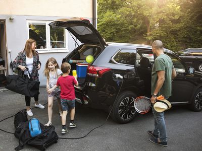 Family loading up the EV for a road trip.