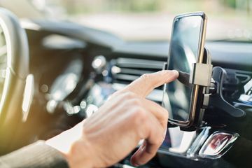 Someone using a smartphone in a car.