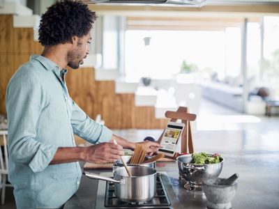 Man cooking using a tablet for recipes