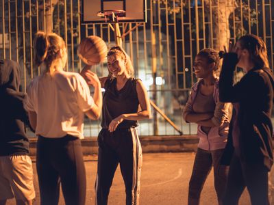 Women standing on a basketball court