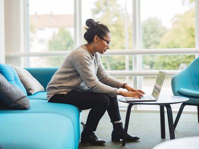 Woman using laptop in living room