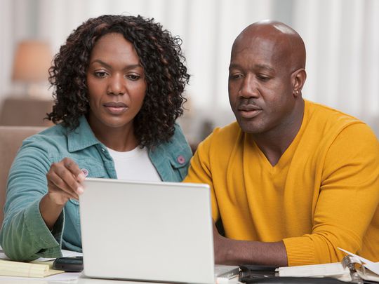 African American couple using laptop together