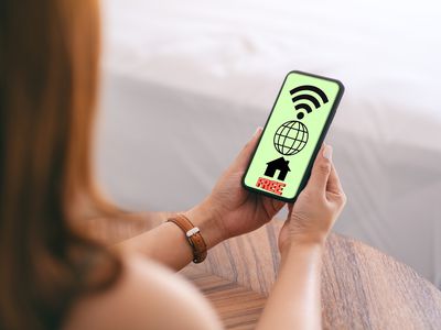 A woman views free internet at home on her phone.