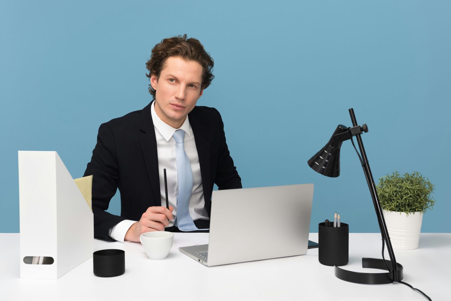 Person at a desk, with a computer.