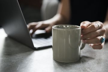 Woman using laptop at coffee shop