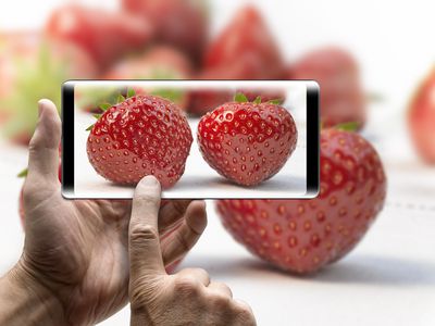 Photo of a smartphone taking a photo of strawberries