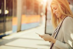 Traveler using Smart Phone at Bus Station