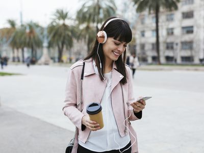 Person on the beach listening to music on a phone