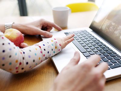 Infant using computer with parent's supervision