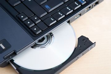 Photo of a CD or DVD ejecting from a laptop