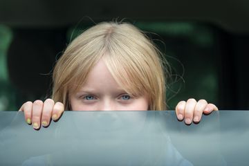 Little girl looking out car window