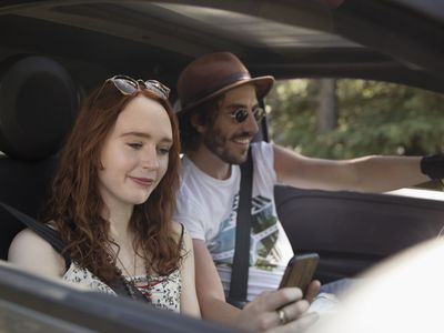 A couple sitting in a car.