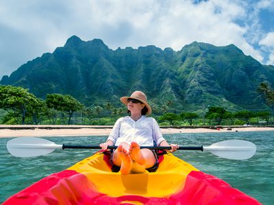 Traveler relaxing in kayak in tropical area on vacation