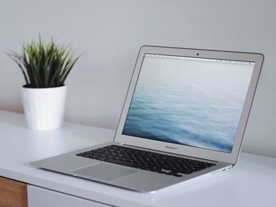 An image of a Macbook Air sitting on a desk