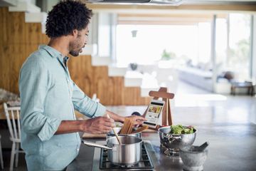 Man cooking using a tablet for recipes